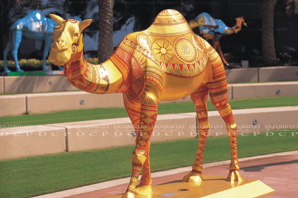 Golden camel sculpture with intricate detailing, standing on a polished base, perfect for luxury decor or gifting
