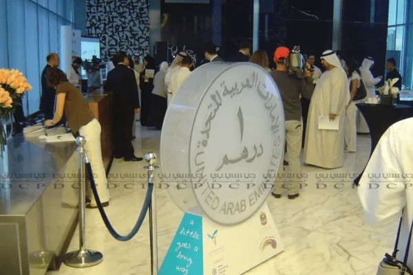 A 3D acrylic representation of the UAE 1 Dirham coin displayed on a sleek stand, featuring intricate details and a crystal-clear finish