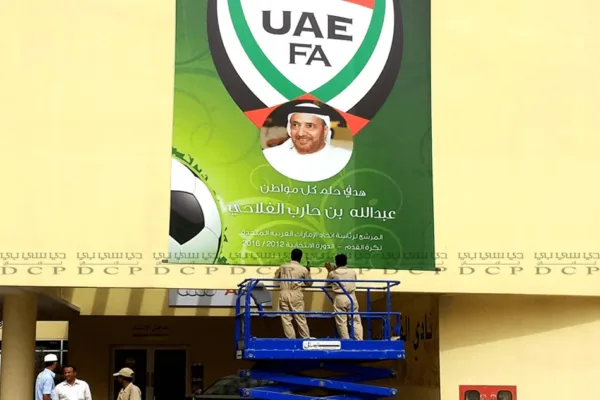 Durable Poster Sticker with Custom Print by DCP Durable poster sticker with custom print displayed on a glass wall, featuring vibrant colors and sharp design